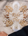 Bride's ivory leather jacket featuring zodiac embroidery – a custom and chic cover-up, making it an ideal gift from bridesmaids for the ride-or-die bride