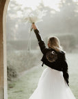 Bride's custom leather jacket featuring intricate zodiac embroidery, a stylish and edgy choice for a celestial-themed wedding ensemble