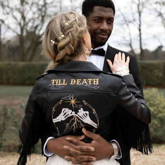 Black cropped bride leather jacket with fringe details – a stylish and edgy choice for a gothic or celestial-themed wedding ensemble, featuring intricate embroidery