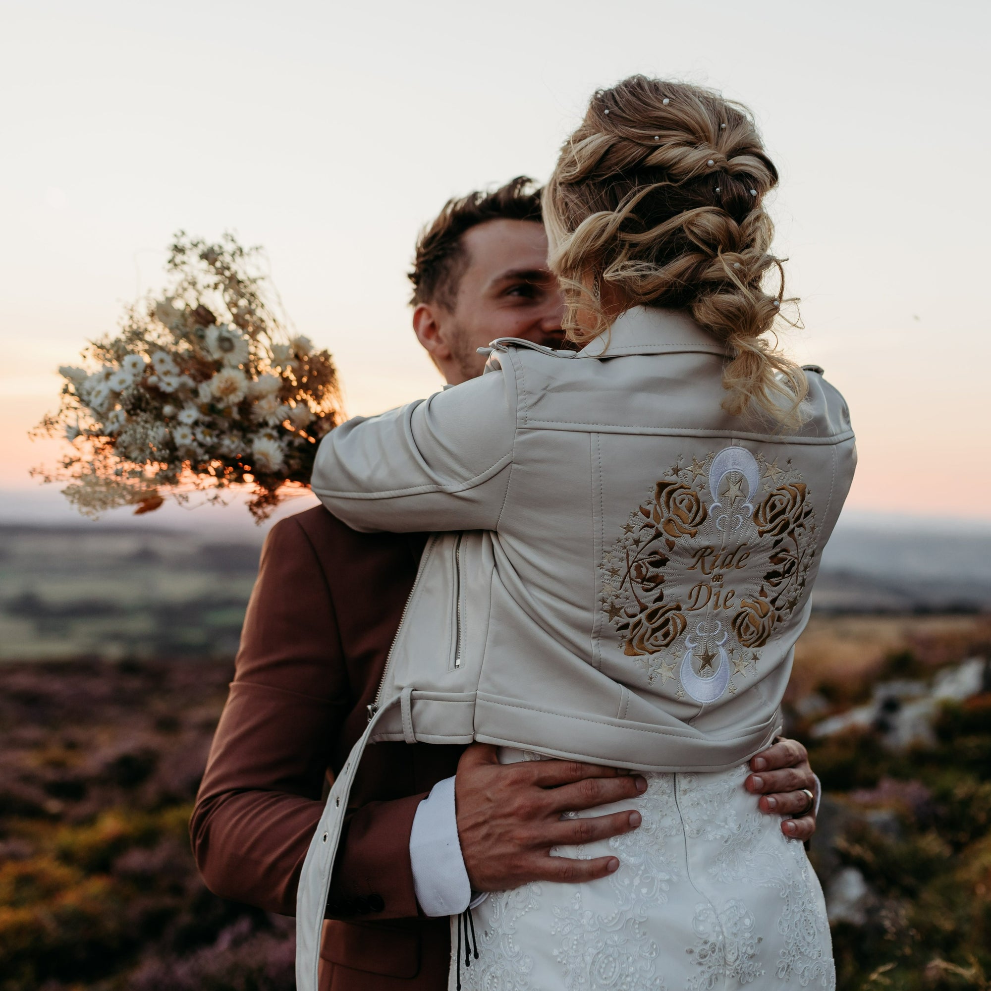 Chic Ride or Die Wedding Jacket: Infuse your bridal style with attitude by donning this ivory cover-up, adorned with bold embroidery for a &#39;Ride or Die&#39; bridal statement