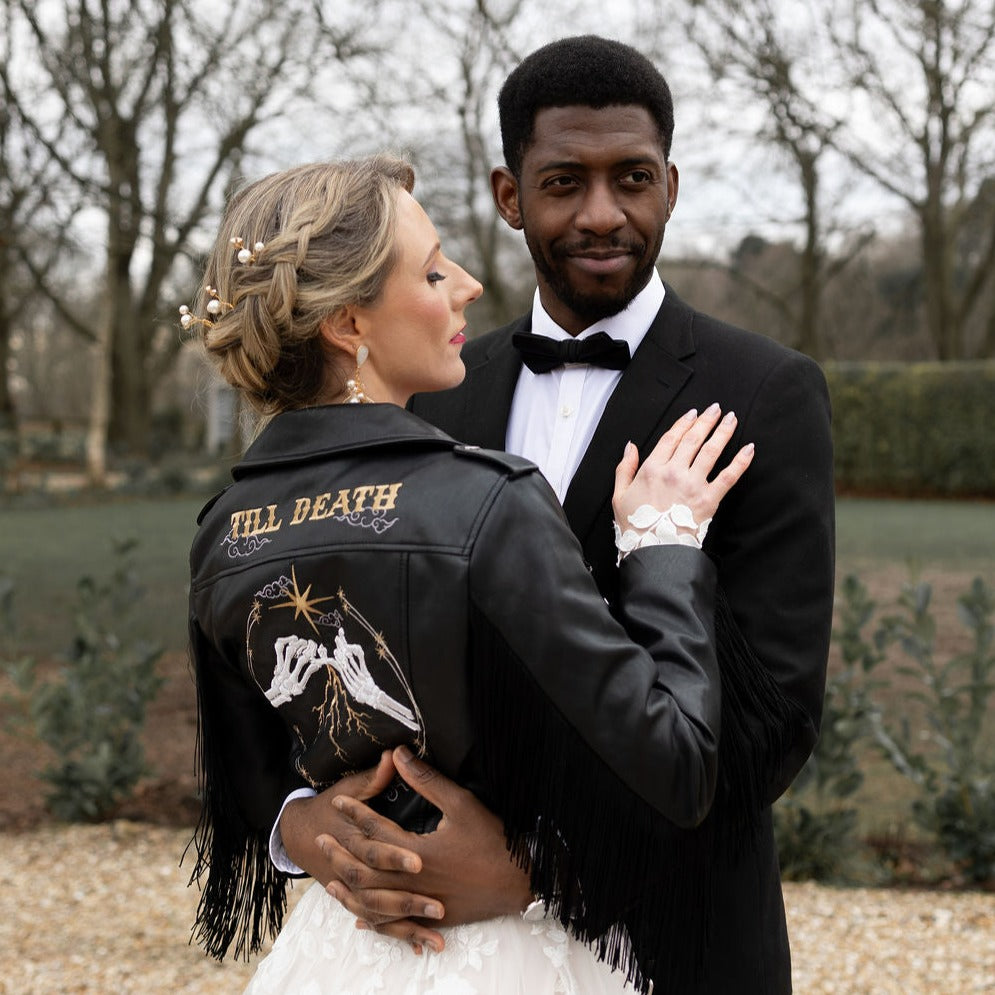 Gothic wedding black leather jacket with fringe and celestial details – a custom embroidered bridal cover-up that adds an edgy touch to your wedding ensemble