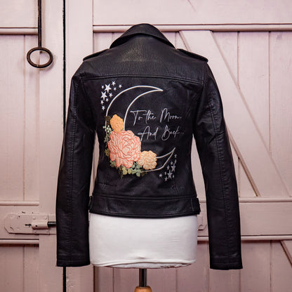 Floral Moon To The Moon & Back Bride-themed Bridal Cover-Up – a black leather jacket for a dreamy and stylish wedding statement