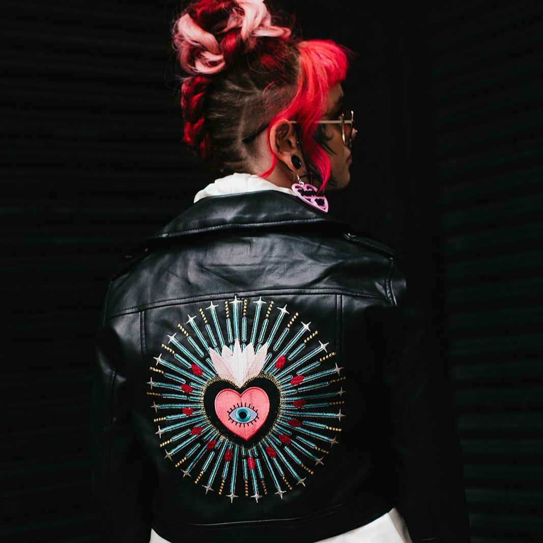 Evil Eye-themed cropped bridal jacket in black leather, a custom biker-inspired cover-up for brides who want a bold and contemporary twist to their wedding ensemble