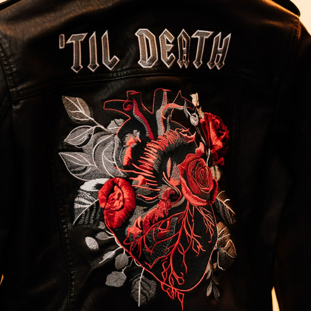 Rock your wedding day with this black leather jacket adorned with a detailed anatomical heart – a unique and alternative choice for the modern bride
