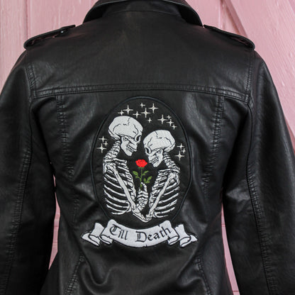 Black leather bridal jacket featuring a Gothic Skeleton Couple – Till Death, a chic and edgy cover-up for the modern bride