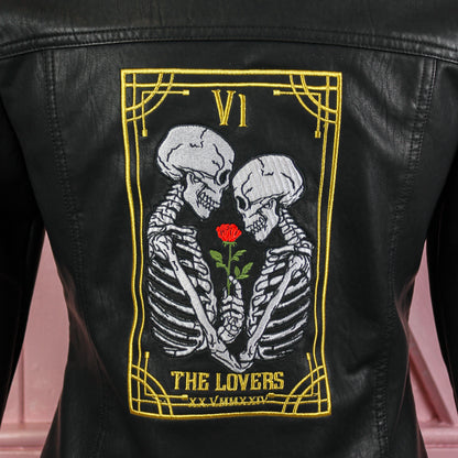 Black leather bridal jacket featuring a Gothic Tarot Card – The Lovers, a chic and mystical cover-up for the modern and unconventional bride