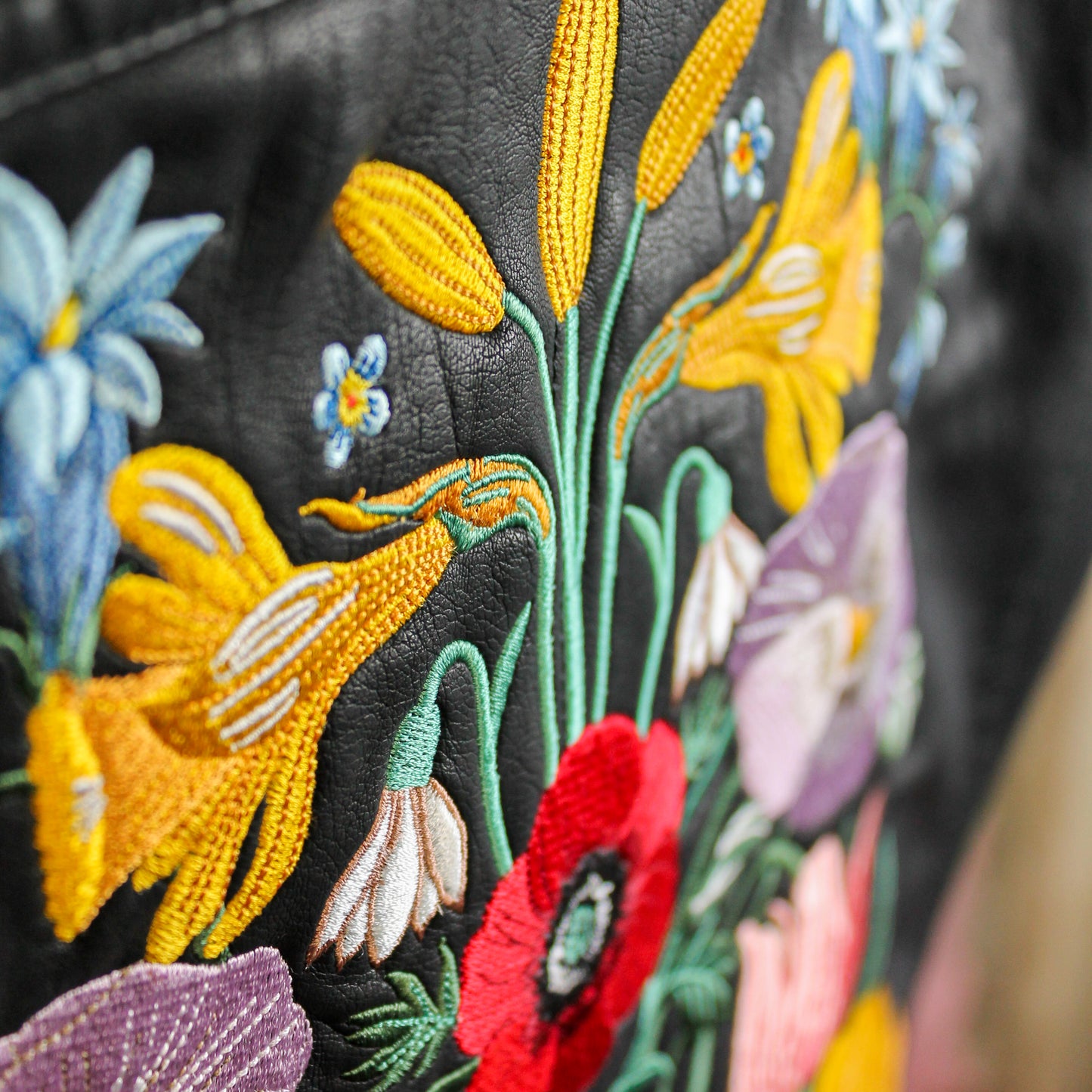 Custom bridal leather jacket adorned with elegant floral patterns
