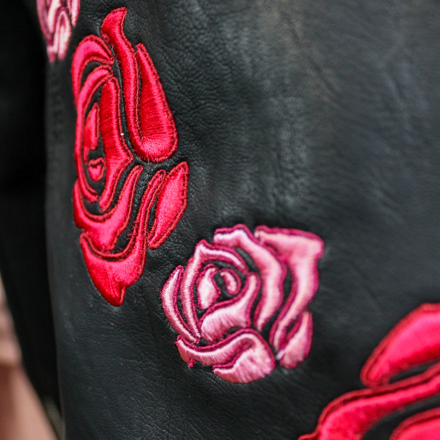 Unique black bride jacket adorned with custom floral embroidery