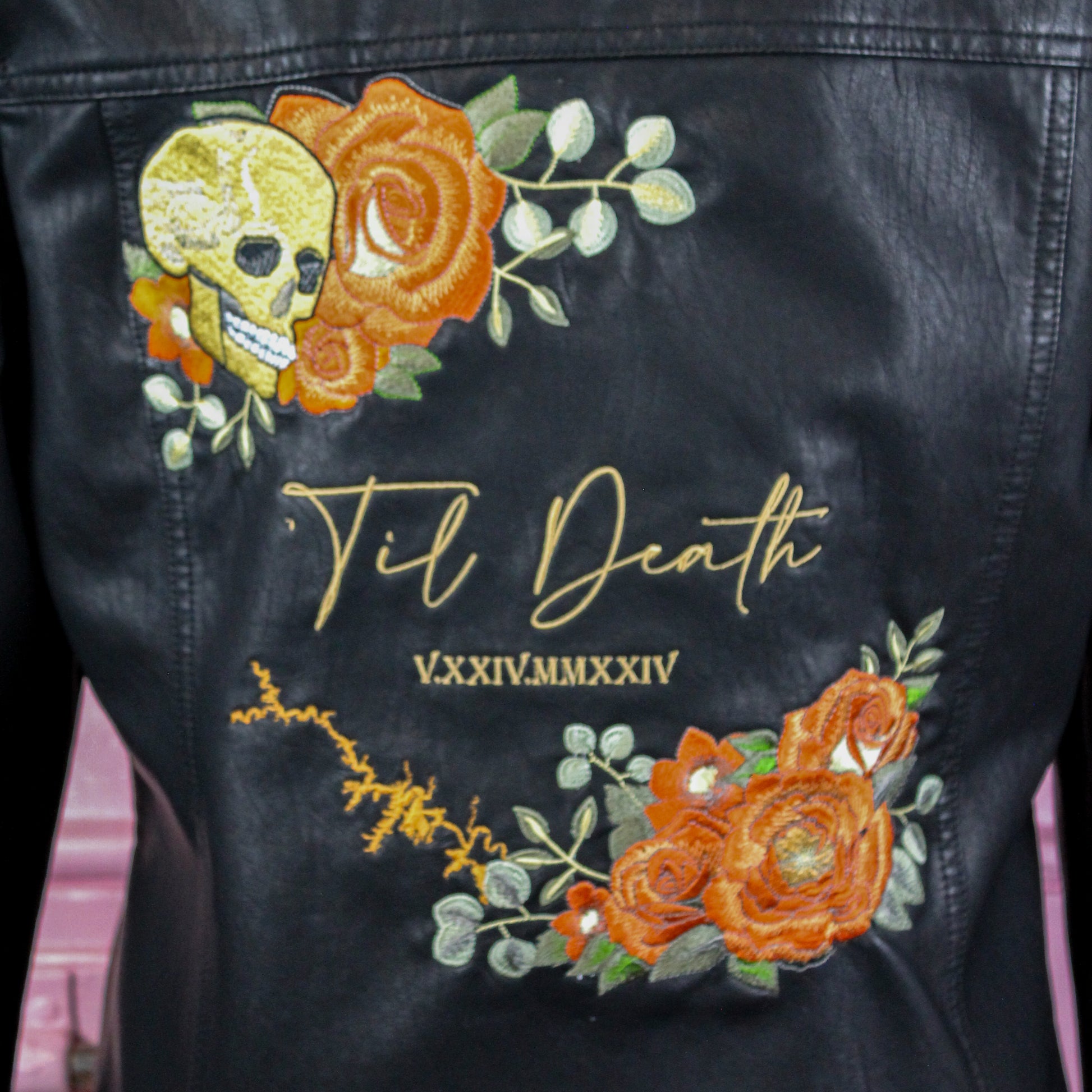 Unique bridal cover-up: black leather jacket with custom floral embroidery
