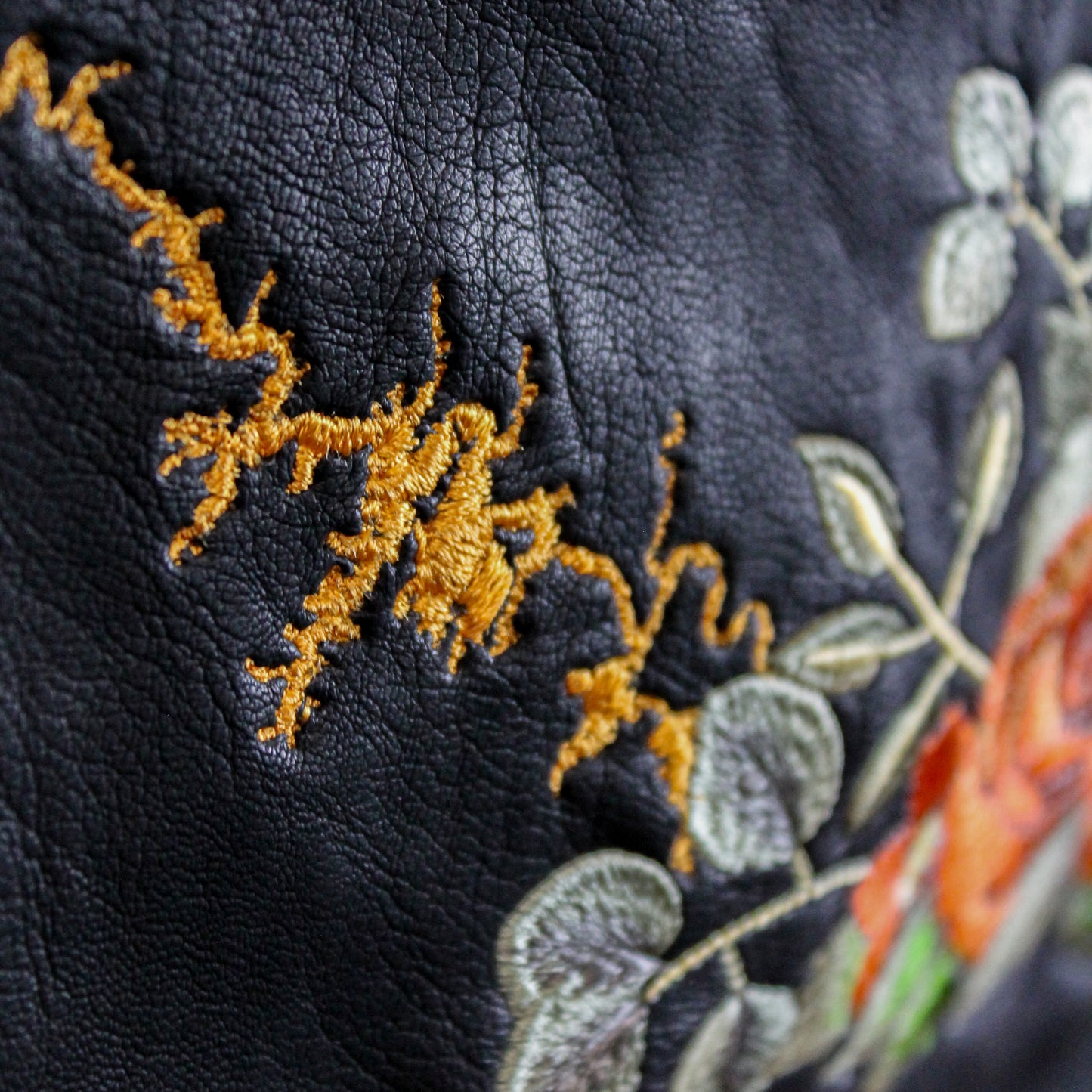 Customized black leather jacket with gothic-inspired floral embroidery