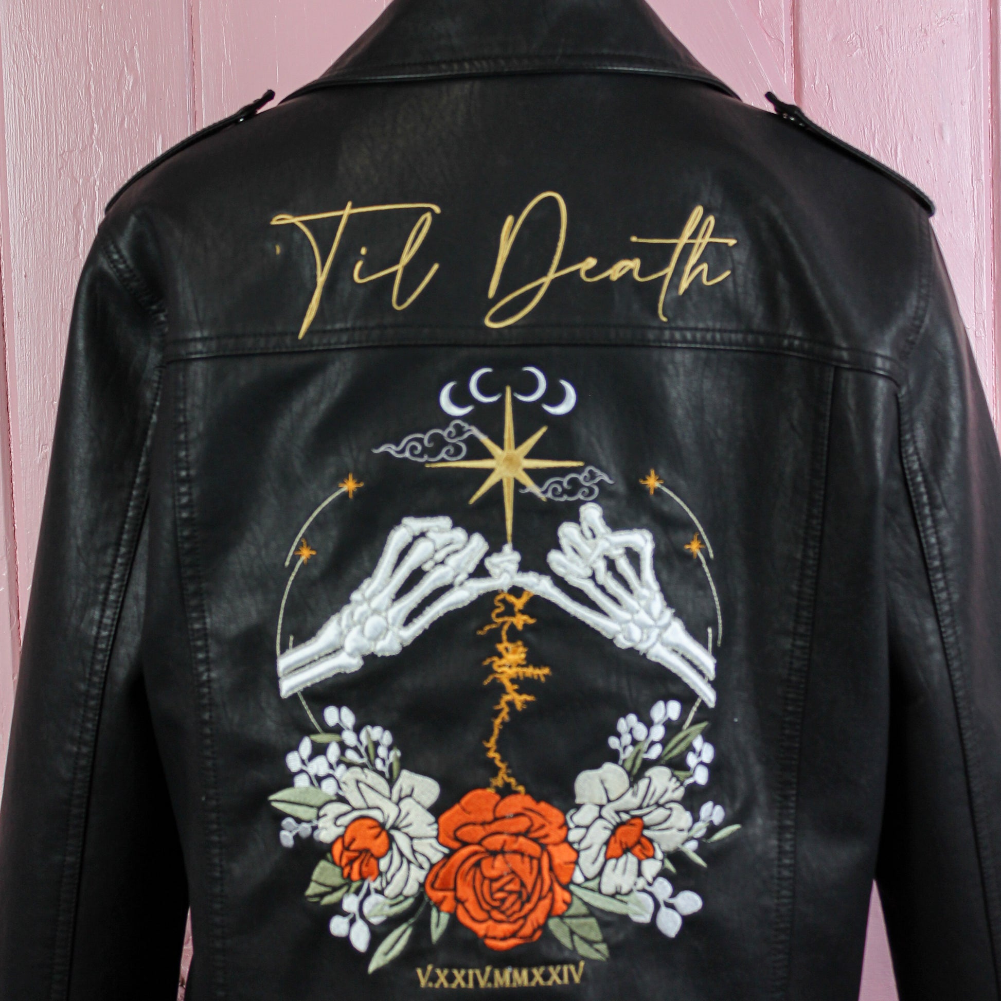 Bride's black leather jacket with celestial and floral motifs