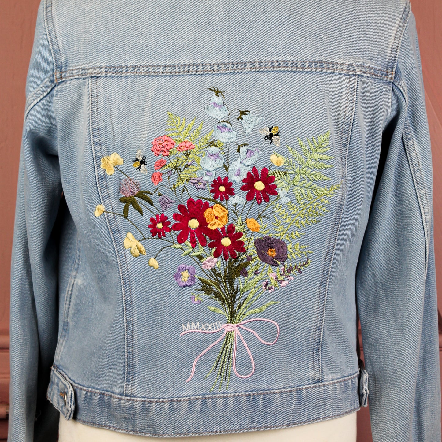Floral Delight Denim Bridal Cover Up: Infuse your wedding ensemble with the beauty of nature through this denim jacket, adorned with a lovely flower bouquet embroidery in ecru