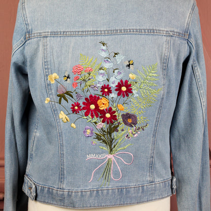 Floral Delight Denim Bridal Cover Up: Infuse your wedding ensemble with the beauty of nature through this denim jacket, adorned with a lovely flower bouquet embroidery in ecru