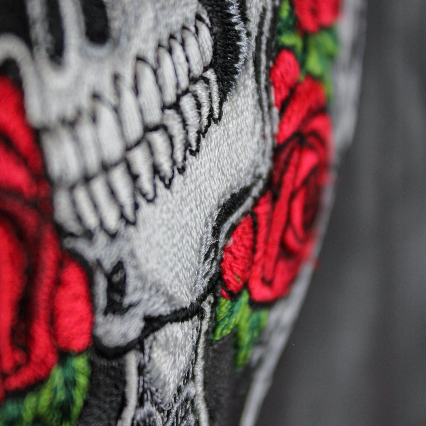 Embroidered skull design on children's black leather jacket
