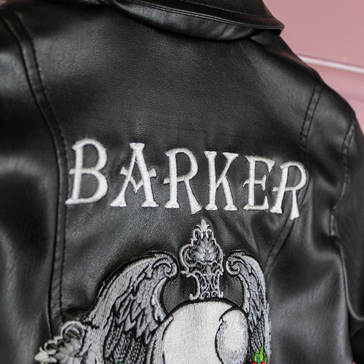 Black leather jacket for kids featuring custom name embroidery