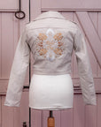 Bridal cover-up with zodiac embroidery, a thoughtful gift from bridesmaids to the bride – a custom ivory leather jacket for a memorable wedding day.