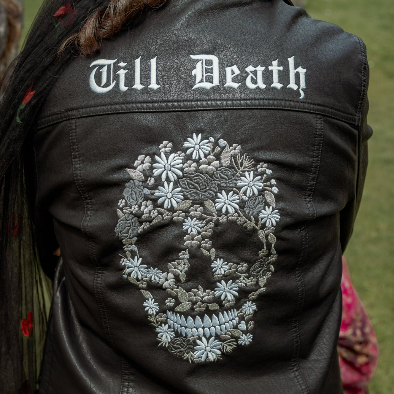 Black leather bridal jacket featuring a Floral Skull Till Death Bride – a chic and unique cover-up for the bold and rebellious bride