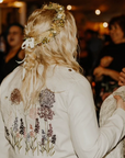 Wildflowers Bridal Cover Up: Add a touch of natural beauty to your wedding ensemble with this ecru embroidered jacket, adorned with delicate wildflowers for a whimsical and romantic feel