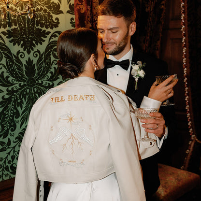 Bridal cover-up in ivory with Zodiac embroidery and Pinky Promise from Skeleton Couple – a unique and custom leather jacket for brides looking to add a personal touch to their ensemble