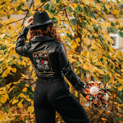 Skeleton couple-themed black bride leather jacket with The Lovers Tarot Card – a custom and edgy bridal cover-up for a wedding ensemble with a touch of the macabre