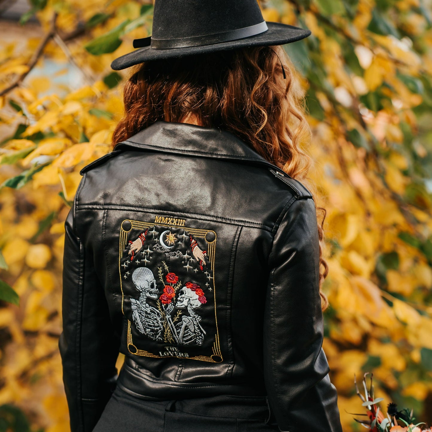 The Lovers Tarot Card black leather jacket for brides – a custom and mystical bridal cover-up featuring a skeleton couple, adding a unique and symbolic touch to your wedding look