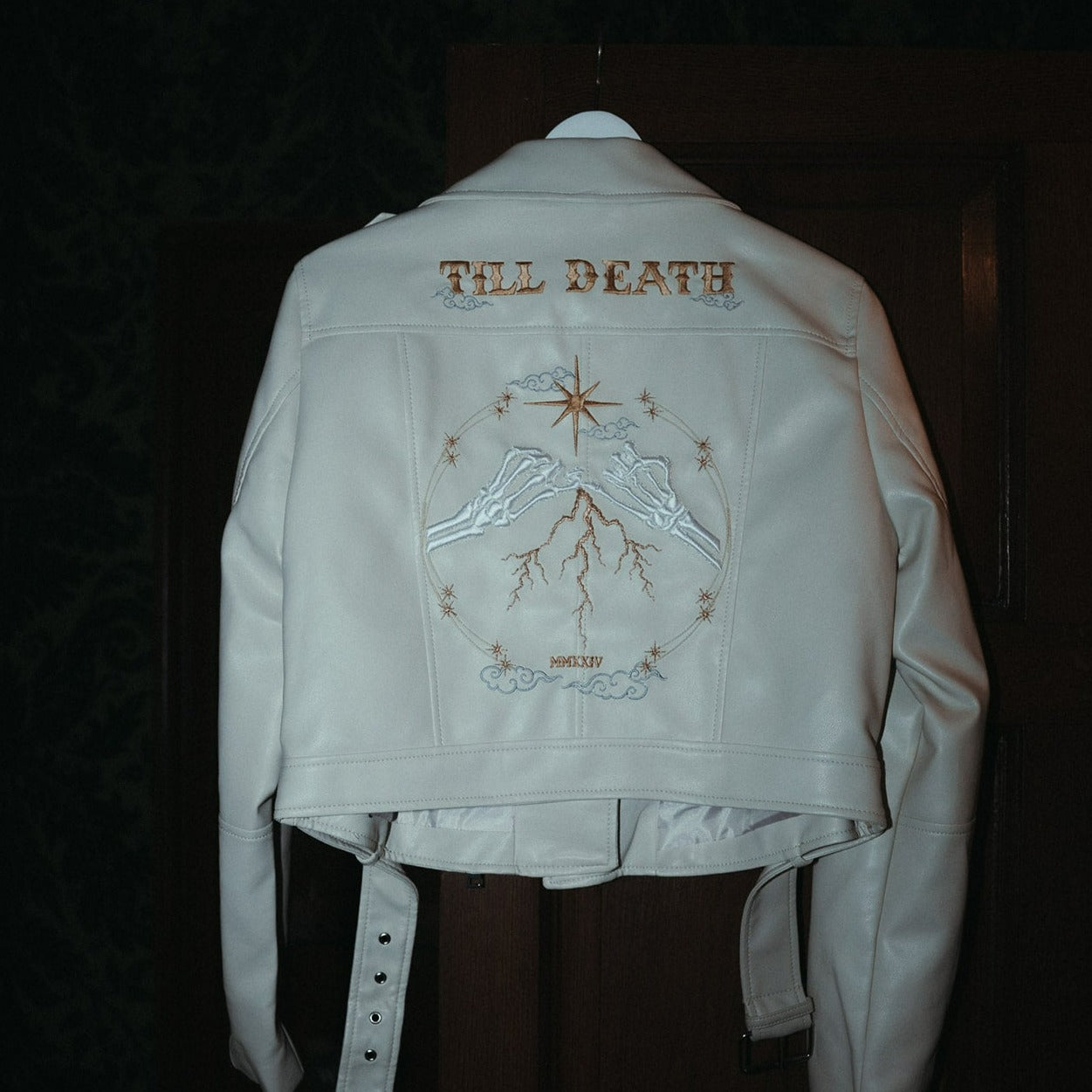 Bride&#39;s ivory leather jacket featuring Zodiac embroidery and a Skeleton Couple Pinky Promise – a whimsical and custom bridal cover-up for a standout wedding ensemble