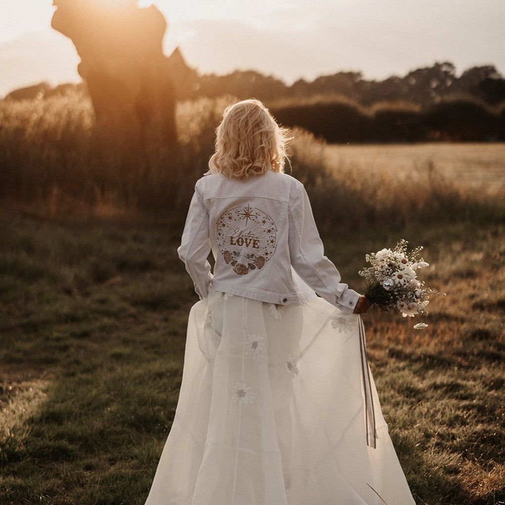 Electric Love Denim Bridal Cover Up: Amp up your wedding style with this ecru embroidered jacket, featuring a vibrant 'Electric Love' design for a bold and modern bridal statement
