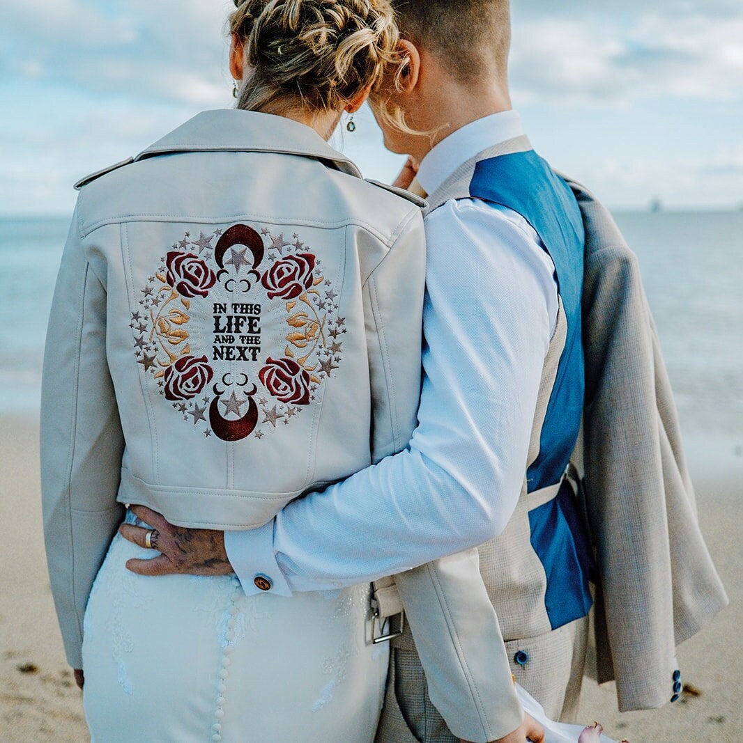 Custom ivory cropped bride leather jacket with zodiac embroidery – a chic and personalized bridal cover-up, a heartfelt gift from bridesmaids saying 'In this Life & the Next'