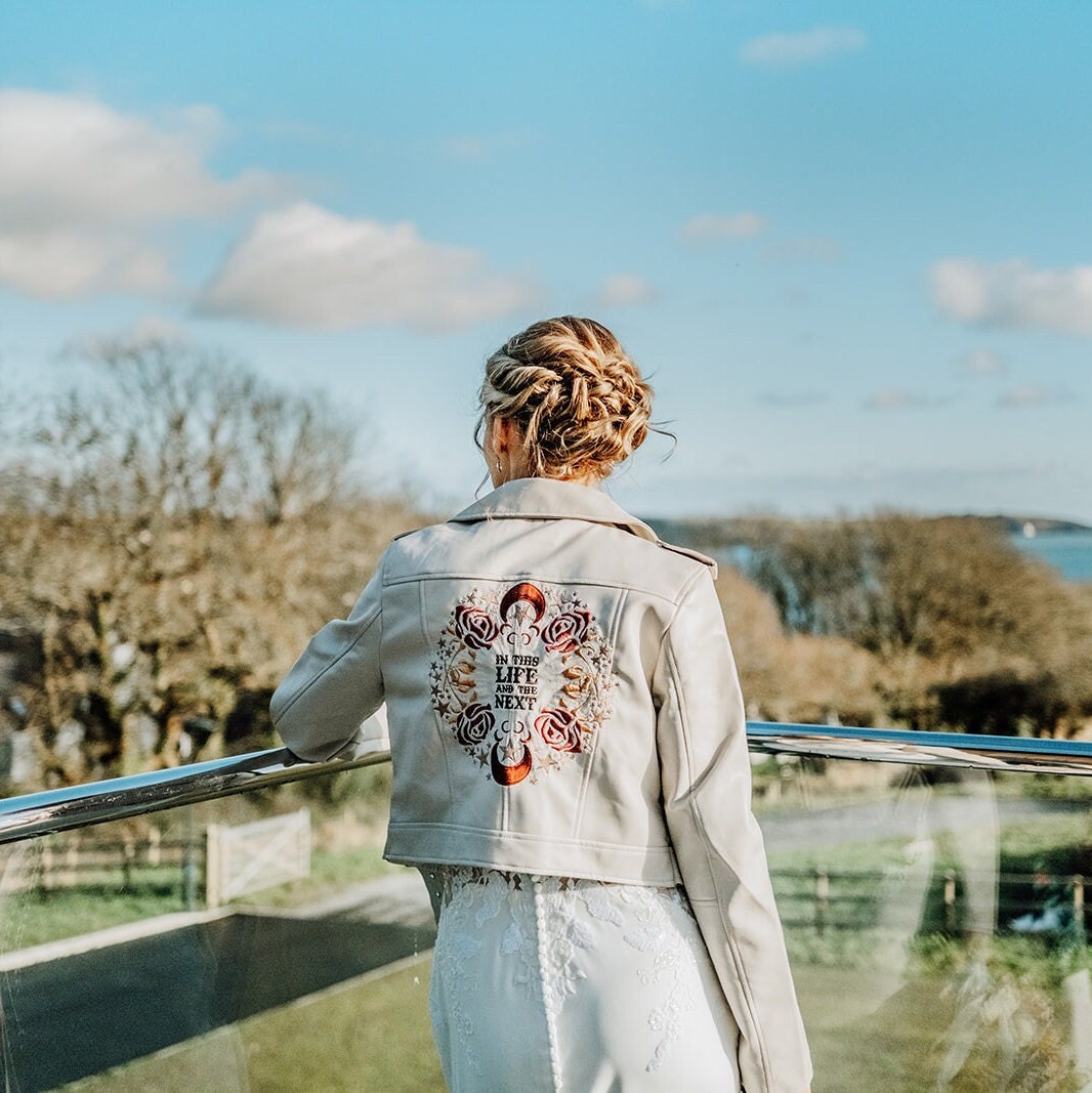 Zodiac-inspired embroidered ivory bridal jacket – a custom cover-up and a thoughtful 'In this Life & the Next' gift from bridesmaids, symbolizing the enduring bond with the bride